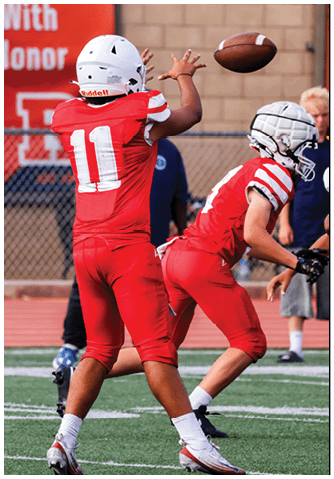 A football player catching a ball. Description generated by AI