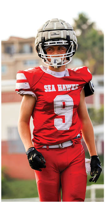 A football player catching a ball. Description generated by AI