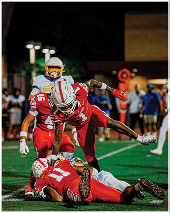 A football game is taking place with a group of men on the field. Description generated by AI