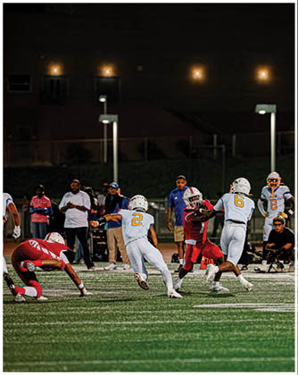 A football game is taking place with a group of men on the field. Description generated by AI