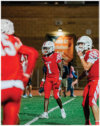 A football game is taking place with a group of men on the field. Description generated by AI