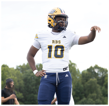 A person wearing a yellow football helmet and white jersey with the number 10 and the letters RBS stands outdoors with one hand on their hip. Description generated by AI