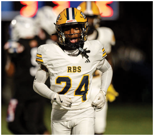 A person wearing a white football uniform with the number 24 and a yellow helmet is running on a field during a game. Description generated by AI
