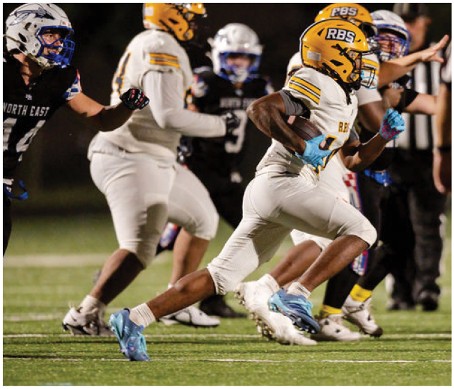 Several people in football uniforms are actively running on a field during a game, with one player in a white and yellow uniform prominently carrying the ball. Description generated by AI