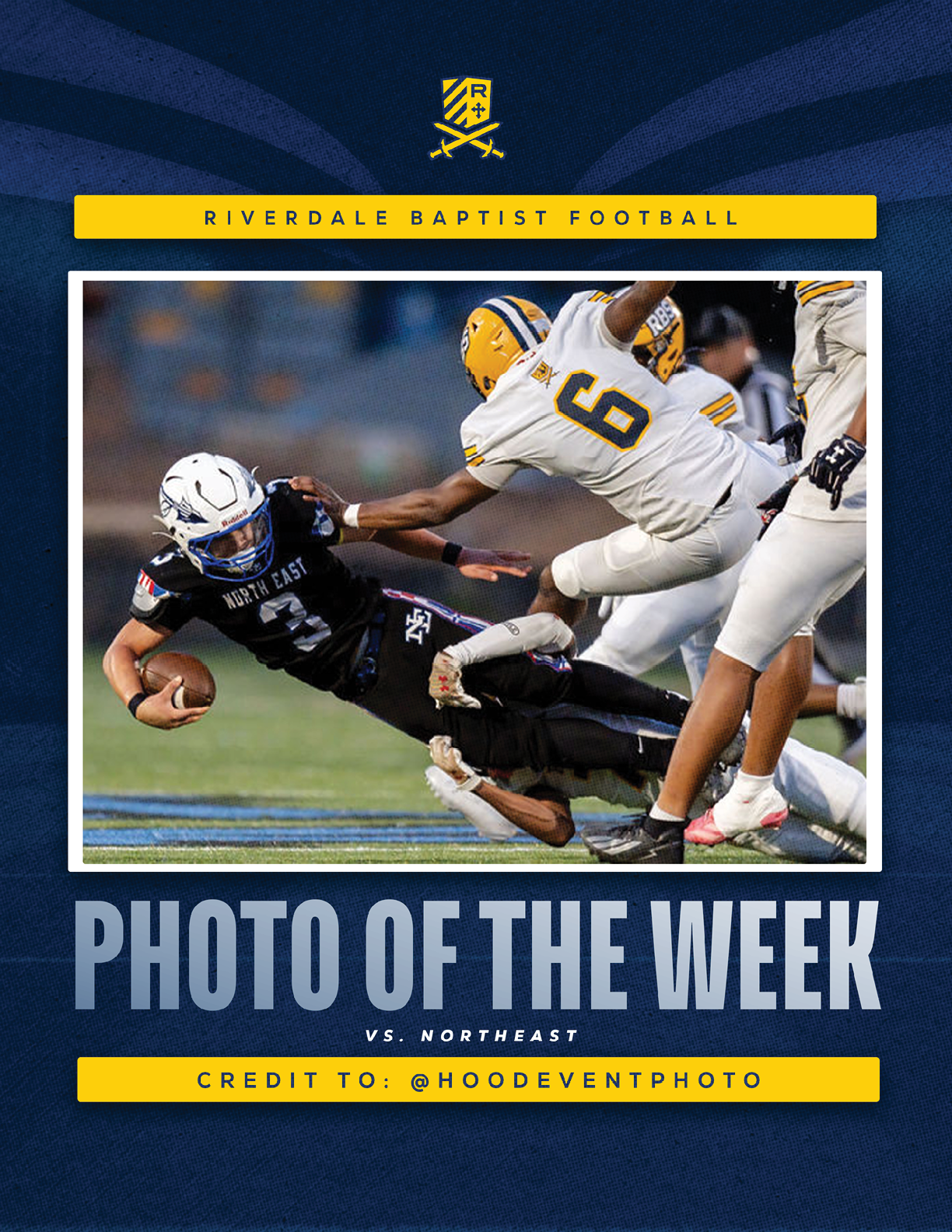 A person in a black football uniform is diving forward while holding a football as two people in white and yellow football uniforms attempt to tackle them on a field. Description generated by AI