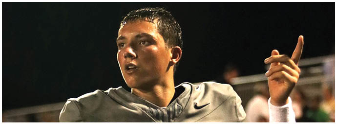 A football player wearing a blue and white uniform. Description generated by AI