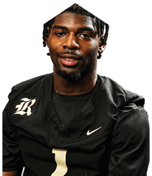 A young man wearing a white jersey with the number 10 on it. Description generated by AI