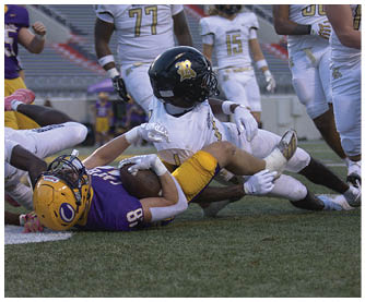 A football player running on the field. Description generated by AI