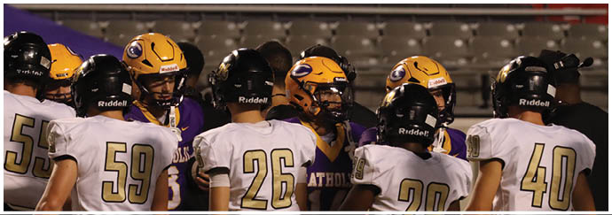 A group of football players on a field. Description generated by AI