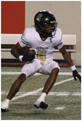 A football player running on the field. Description generated by AI