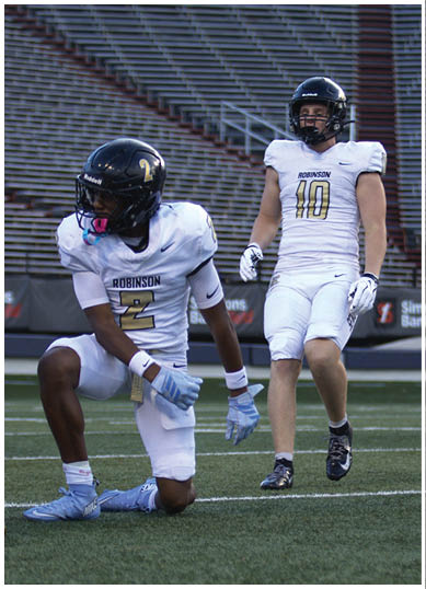 A football player wearing a blue and white uniform. Description generated by AI