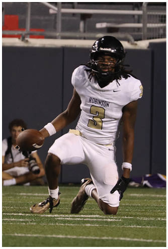 A football player running on the field. Description generated by AI