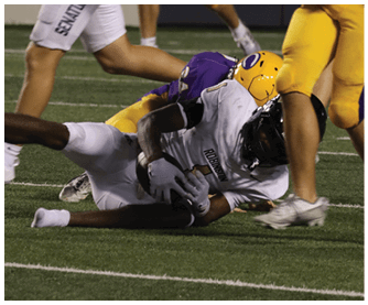 A football player running on the field. Description generated by AI