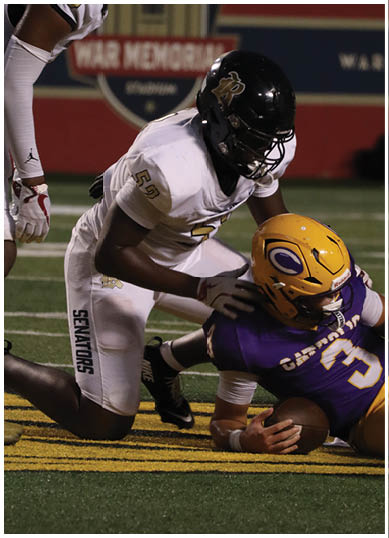 A football player wearing a blue and white uniform. Description generated by AI