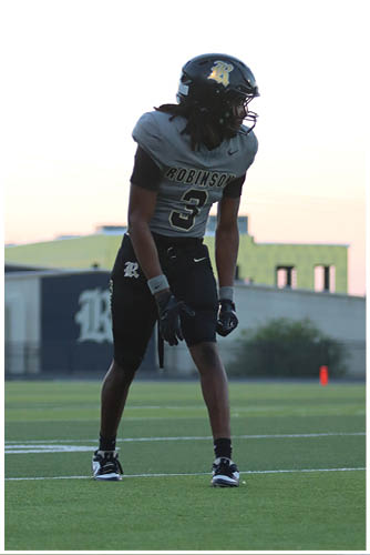 A football player running on the field. Description generated by AI