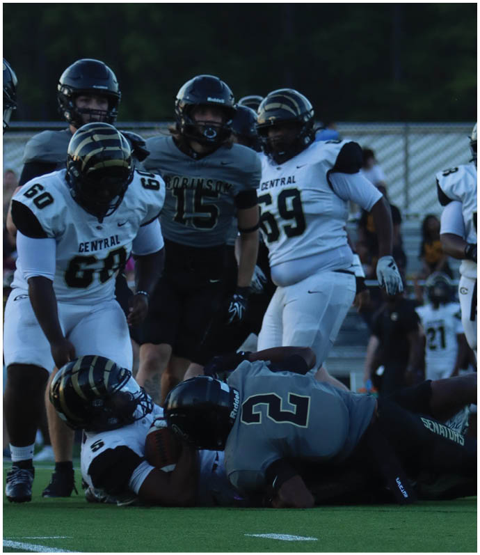 A group of football players wearing black and white uniforms. Description generated by AI