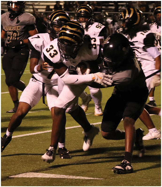 A group of football players wearing black and white uniforms. Description generated by AI