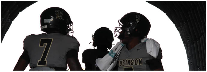 A group of football players on a field. Description generated by AI