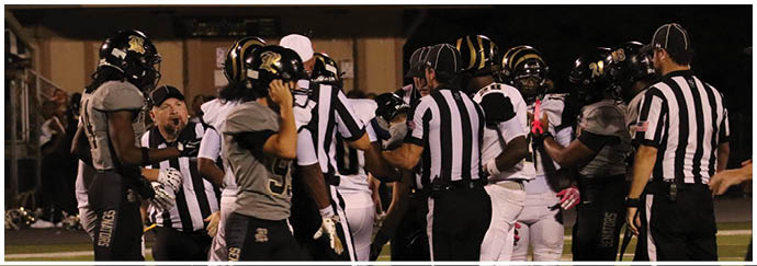 A group of football players on a field. Description generated by AI