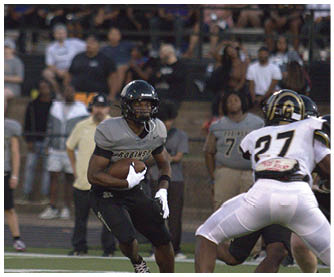 A football player running on the field. Description generated by AI