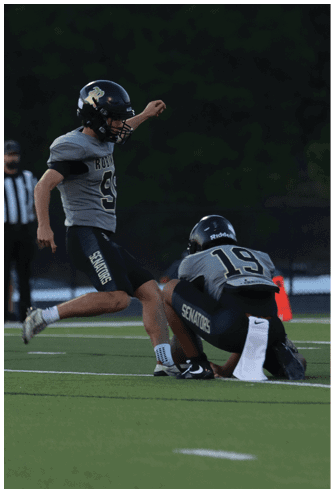 A football player running on the field. Description generated by AI