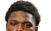 A young man wearing a white jersey with the number 10 on it. Description generated by AI