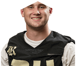 A young man wearing a white jersey with the number 10 on it. Description generated by AI