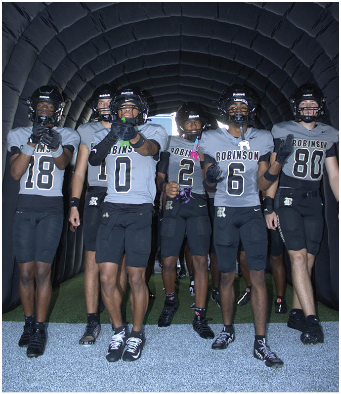 A group of football players wearing black and white uniforms. Description generated by AI