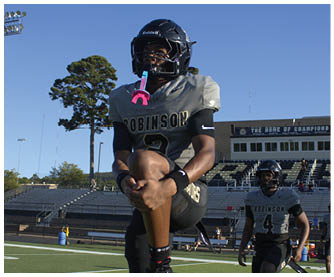A football player running on the field. Description generated by AI