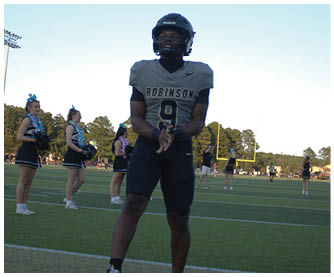 A football player running on the field. Description generated by AI