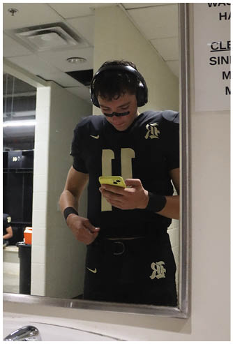 A football player running on the field. Description generated by AI