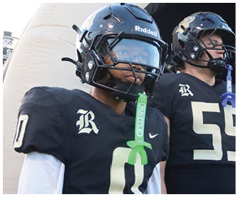 A football player running on the field. Description generated by AI