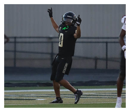 Two football players celebrating a touchdown with one player jumping in the air. AI generated content