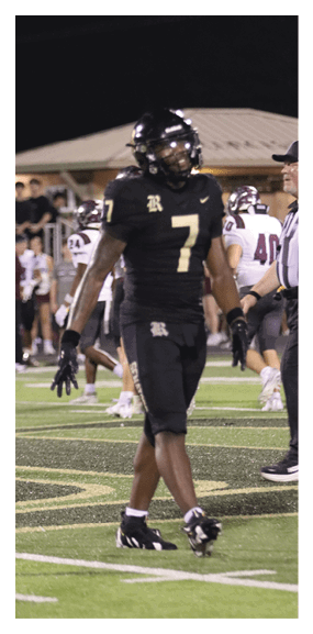 A man in a green shirt and black pants is preparing to throw a football. AI generated content
