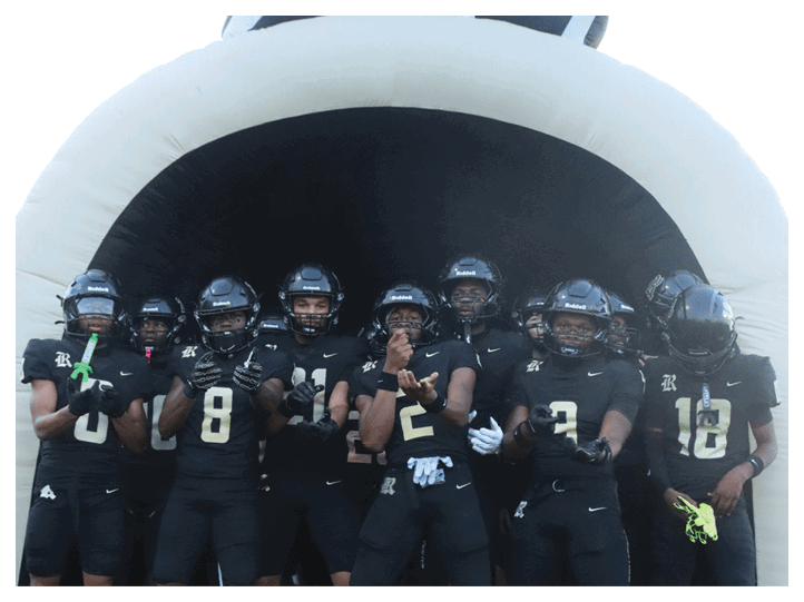 A group of football players on a field, one of them is running with a football. AI generated content