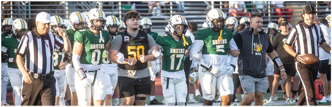 A group of football players on a field. Description generated by AI
