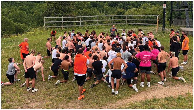 A group of football players on a field. Description generated by AI