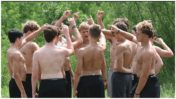 A group of football players on a field. Description generated by AI