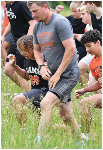 A football player running on the field. Description generated by AI