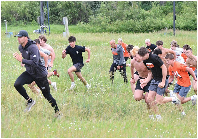 A group of football players wearing black and white uniforms. Description generated by AI