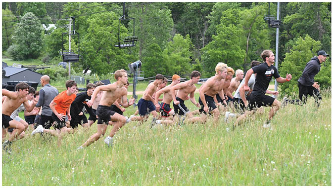 A group of football players on a field. Description generated by AI