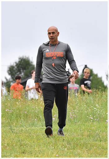 A football player running on the field. Description generated by AI
