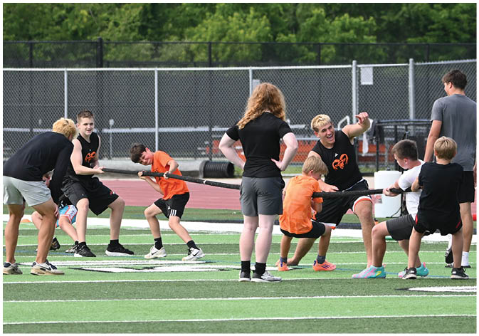A group of football players wearing black and white uniforms. Description generated by AI