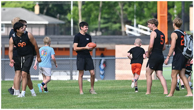 A group of football players on a field. Description generated by AI