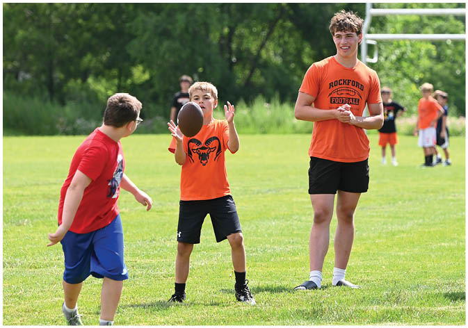 A group of football players wearing black and white uniforms. Description generated by AI