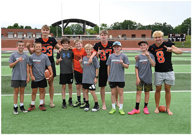 A group of football players wearing black and white uniforms. Description generated by AI
