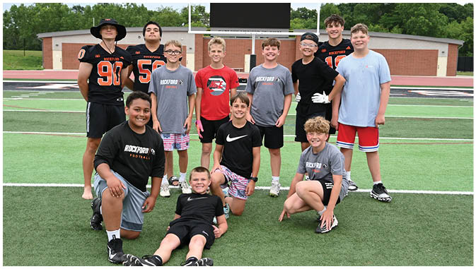 A group of football players on a field. Description generated by AI