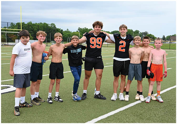 A group of football players wearing black and white uniforms. Description generated by AI