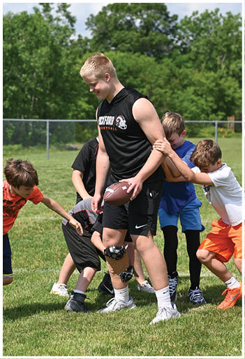 A football player running on the field. Description generated by AI
