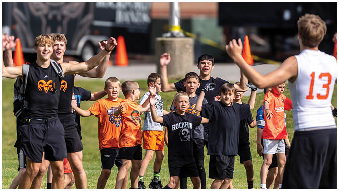A group of football players on a field. Description generated by AI